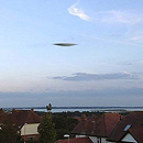 Photo: Silver disc-like UFO spotted moving over city as the Met Office say it ISN'T a cloud